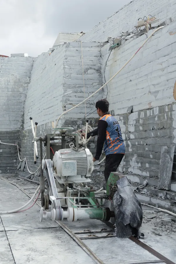 A cutting machine working along the limestone face in the quarry